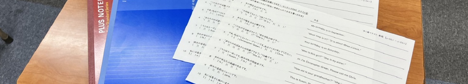 机に並べられたノートと英語のプリント。青山ゼミナールの苦手克服講座で使用する教材の一例。